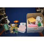 A box of miscellaneous Sindy accessories including garden chair, exercise bike, high chair, dogs,