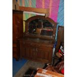 A 1920/30's Oak mirrorback Sideboard having opposing doors to the base,