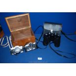 A pair of Mark Scheffel binoculars and two Olympus Cameras in wooden box