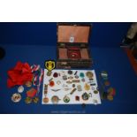 A box of military memorabilia, badges etc.