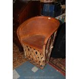 A most unusual tribal type leather upholstered bow back Elbow Chair having hardwood lattice design