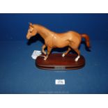A Royal Doulton figure 'My First Horse', Chestnut horse on wooden plinth by Amanda Hughes.