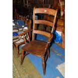 A mixed woods ladderback kitchen Carver Chair having turned legs and arm supports and solid seat