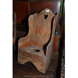 An antique Mahogany high back child's/miniature rocking/Lambing style Chair having commode