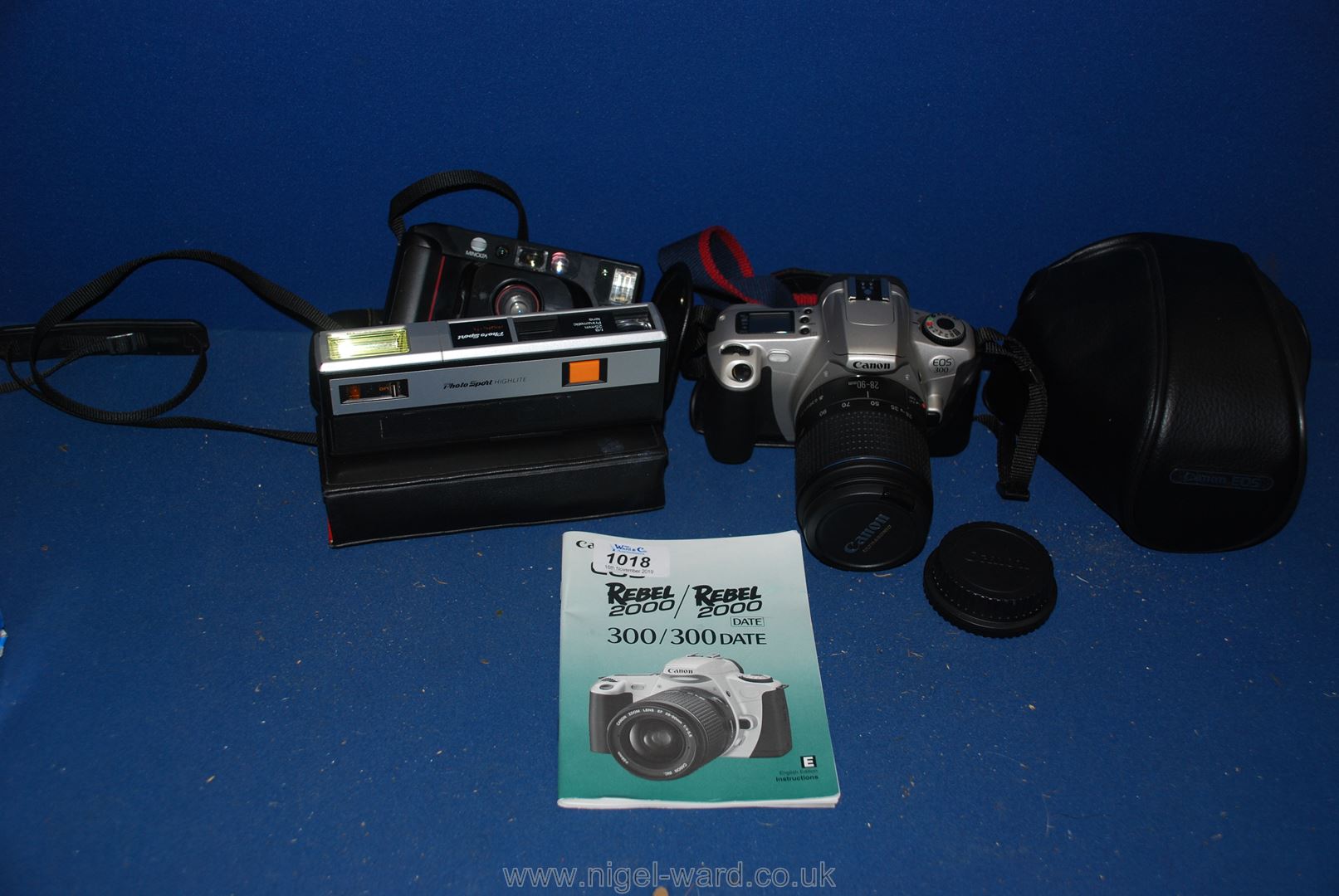 A Minolta AF-DL Camera and case, a photo sport and flash camera,