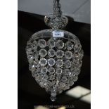 An elegant glass chandelier having a cut and polished glass dome with an electrical fitting