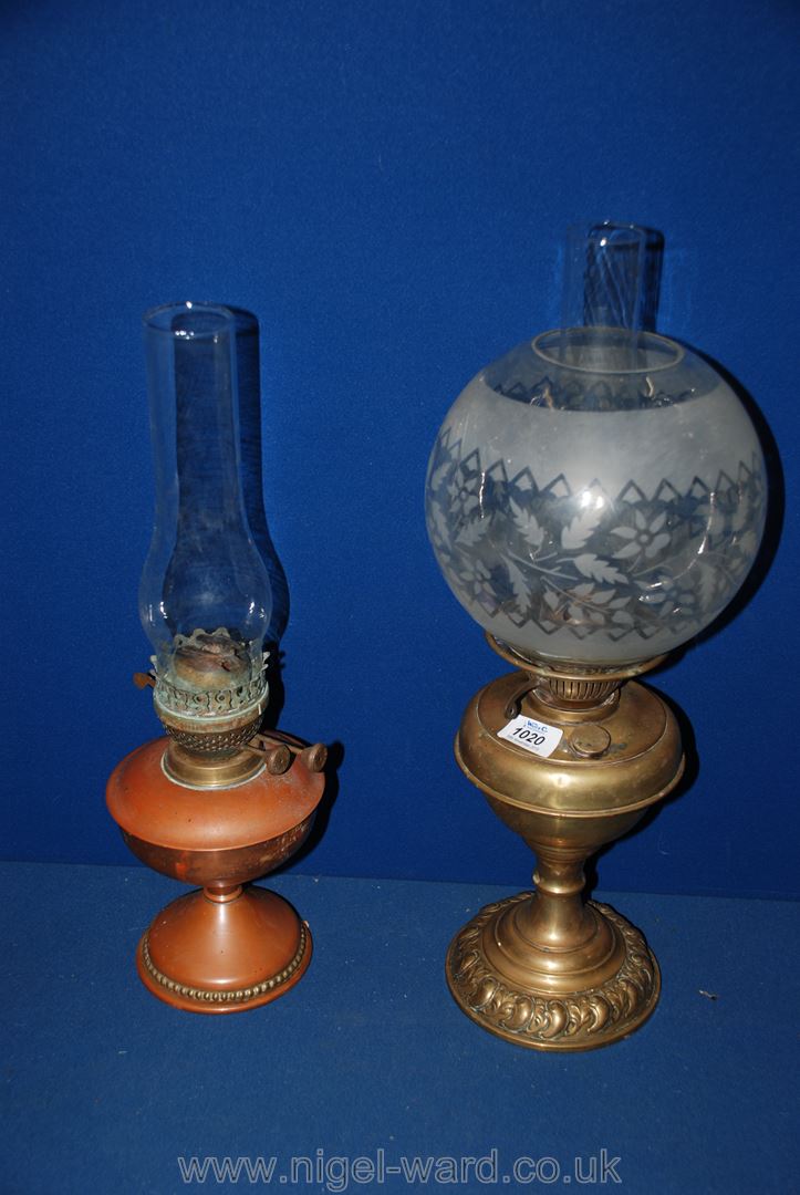 A brass oil Lamp complete with a globe shade plus a copper oil Lamp.