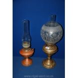 A brass oil Lamp complete with a globe shade plus a copper oil Lamp.