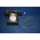 A black Bakelite telephone.
