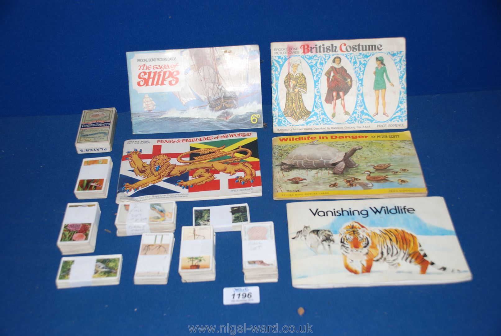 A quantity of Cigarette cards and various books on flags, wildlife, etc.
