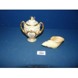 A Coalport lidded gilded Urn with a Royal Worcester conch shell.