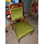 An Edwardian Walnut and Mahogany framed lady's Fireside Chair having fretworked and carved top rail,