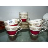 An Aynsley Teaset in burgundy/gold including six cups,