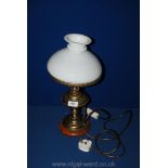 A brass oil Lamp converted to electric with milk coloured shade.