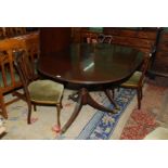 A period dark Mahogany double pedestal d-ended Dining Table standing on turned pillars,