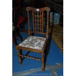 An arts and crafts Mahogany framed side Chair having turned details and fretworked central back