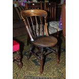A Welsh cottage circular Elm seated Kitchen Chair having turned detail to the legs and back