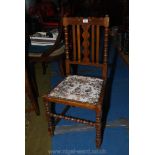 An arts and crafts Mahogany framed side Chair having turned details and fretworked central backrest