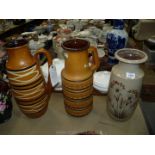 Three large West German pottery Vases, beige with flowers and another.