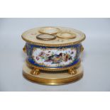 A Paris porcelain inkstand, 19th century, complete with wells and finely painted with flowers.