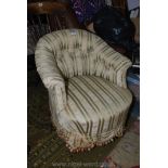 A circa 1900 striped upholstered buttoned back low Armchair of elegant shape having turned front