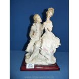 A Capo-di-monte figure of lady and gent, carrying bouquet of flowers.