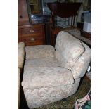 A modern fireside Chair having beige ground foliage and flower patterned fabric upholstery