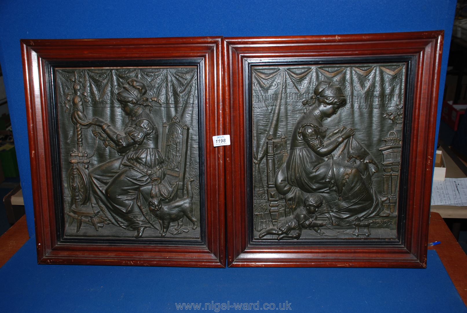 A pair of carved wall plaques.