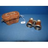A pair of early 20th Century Le Jockey Club Paris binoculars in an old leather case.