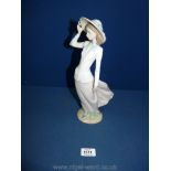 A Lladro figure Nos. 5682, 'young lady with her rimmed hat'.