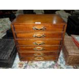 A small six drawer cabinet with fly fishing equipment