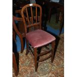 An unusual Edwardian semi-high Chair having boxwood inlaid arched back Mahogany frame and deep puce