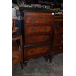 An older reproduction Mahogany and cross-banded Walnut Tallboy of four drawers having pierced