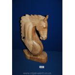 A wooden carved horse's Head.