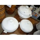 A large white Soup tureen and lid (ladle missing) and two white lidded vegetable dishes.