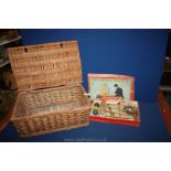 A vintage game 'The Popular Game of Croquet' and a vintage picnic basket.