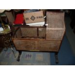 An antique mahogany framed cradle , the sides,