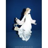 A Lladro figure of a lady in a flowing dress with small flower basket (flower a/f.) Nos. 5898.