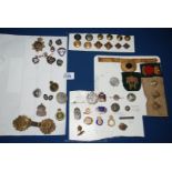 A quantity of military Badges and buttons to include Home Front badges, etc.