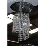 A contemporary chandelier with stainless steel/chromium plated finish and having descending