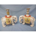 A pair of decorative ceramic elephant vases, 27cm approx.