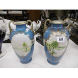A pair of gilded hand painted vases