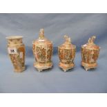 A collection of four Japanese miniature Satsuma vases on stands