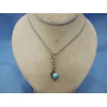 A Turquoise and diamond pendant on silvered chain