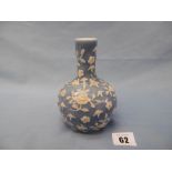 A Chinese blue ground bottle vase with relief enamel, seal mark to base, 14cms approx.