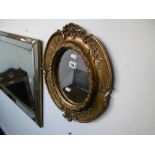 A gilt framed oval mirror, a.