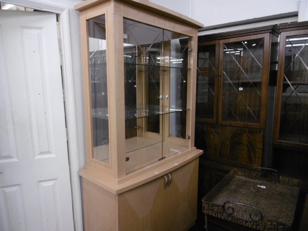 A DECORATIVE DESIGNER DISPLAY CABINET ON CUPBOARD BASE PLUS SIDE UNIT