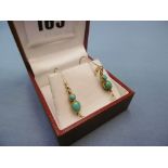 A pair of turquoise & pearl earrings.