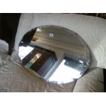 An oval wall hanging mirror