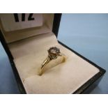 An 18ct gold & platinum brown diamond solitaire ring. Diamond 81 points, ring size L & half.